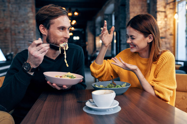 young couple sitting in a restaurant chatting dating - Photo, Image