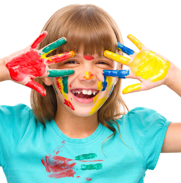 Portrait of a cute girl playing with paints - Fotó, kép