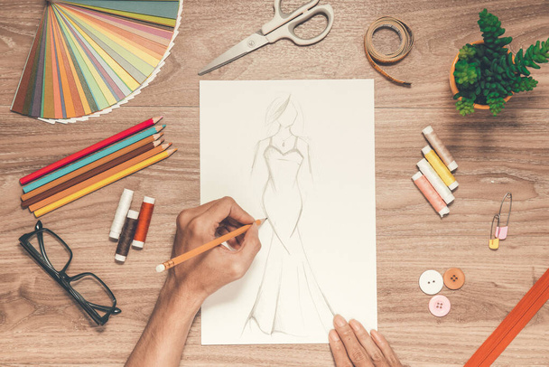 Close-up of designer drawing a fashion sketch - Photo, image