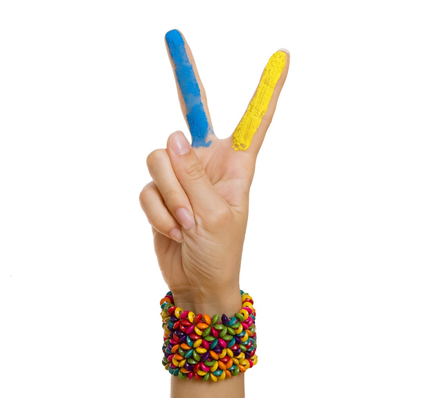 Ukrainian patriotic theme: Hand Giving Peace (Victory) Sign with - Foto, imagen