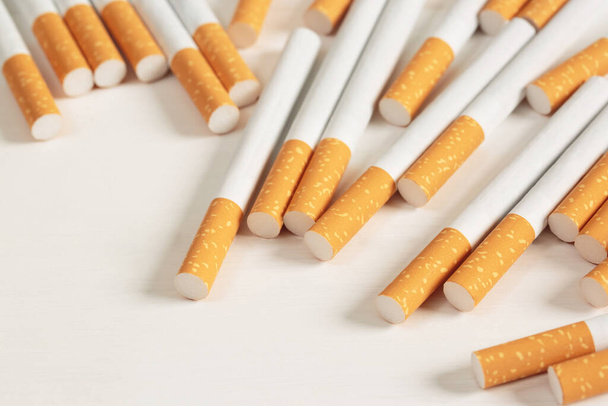 image of several commercially made pile cigarette on white  background. or Non smoking campaign concept, tobacco pattern top view. - Photo, Image