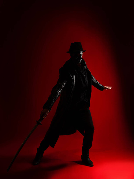 A mysterious ninja assassin in a noir style. A man in black clothes - Fotoğraf, Görsel