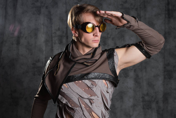 Steampunk or post-apocalyptic style character, a young man in a grunge suit. - Photo, image