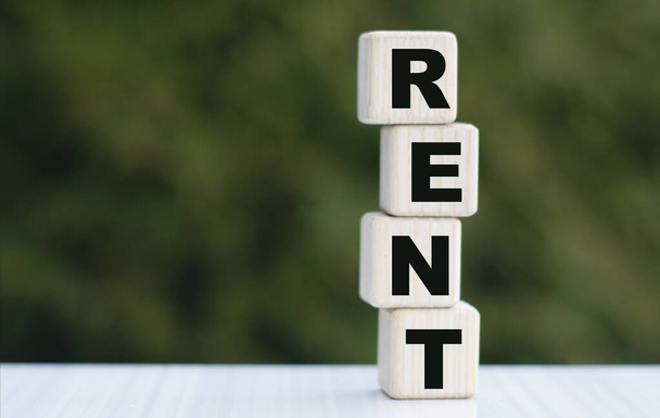 The concept of the word RENT on cubes on a beautiful green background. Business concept. - Foto, Imagem