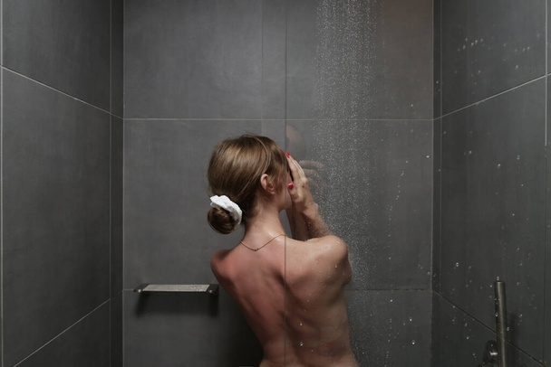 Young beautiful woman taking shower in bathroom - Foto, Bild
