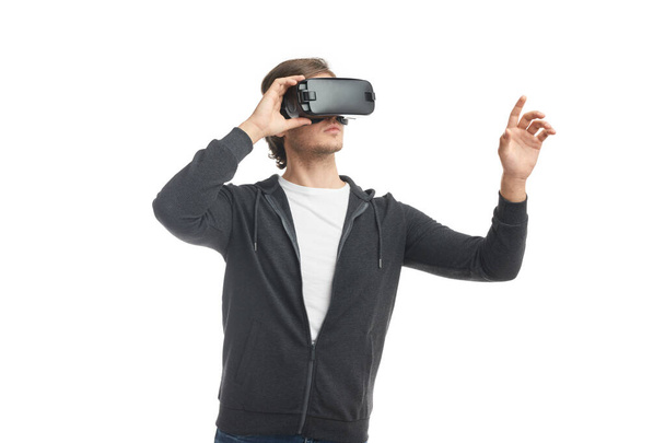 Man in VR goggles touching air - Foto, Imagen