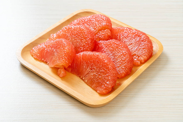 fresh red pomelo fruit or grapefruit on plate - Φωτογραφία, εικόνα