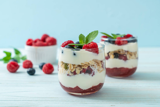 homemade raspberry and blueberry with yogurt and granola - healthy food style - Fotó, kép
