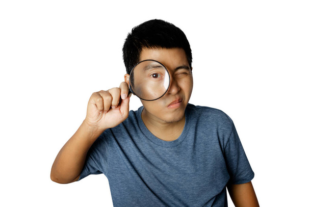 Young man with magnifying glass isolated on white background. - Photo, Image