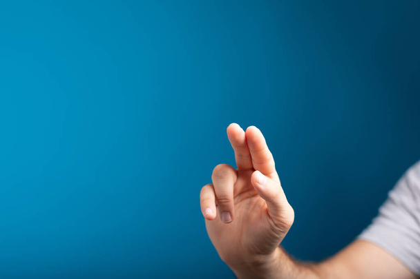 A closeup of a Caucasian man holding his fingers in the air - pressing on a touch screen concept - Foto, immagini