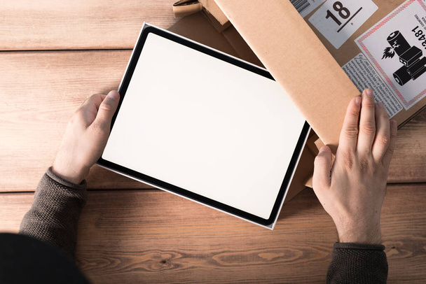 A top view shot of a tablet in a box with blank screen - Fotoğraf, Görsel