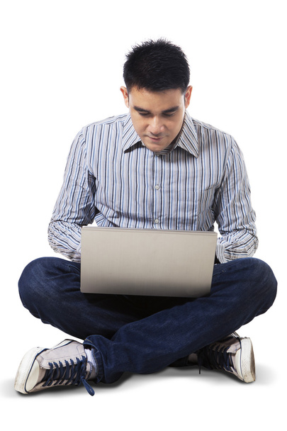 Man using laptop computer seriously - Photo, image