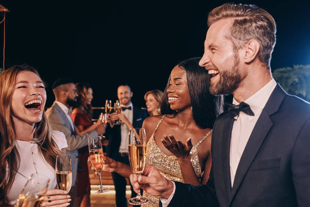 Group of beautiful people in formalwear communicating and smiling while spending time on luxury party - Φωτογραφία, εικόνα
