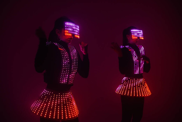 Two sexy disco dancers move in UV costumes. Parties and dances. - Foto, immagini
