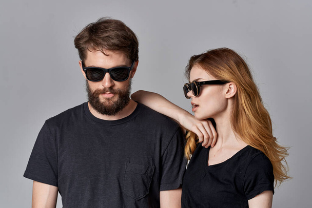 fashionable man and woman socializing together posing fashion light background - Photo, Image