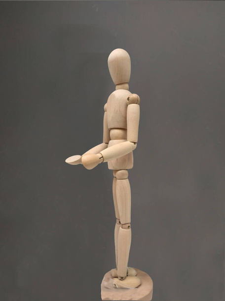 wooden human body figure posing in profile, in a philosophical p - Photo, Image