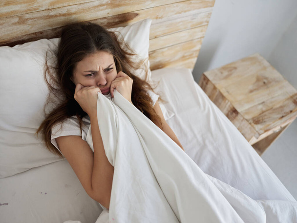 sad woman holding blanket in bed morning - Foto, Imagem