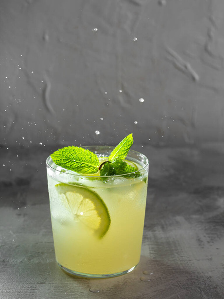 Lemon soda with lemon and mint, cold refreshing drink or beverage with ice - 写真・画像