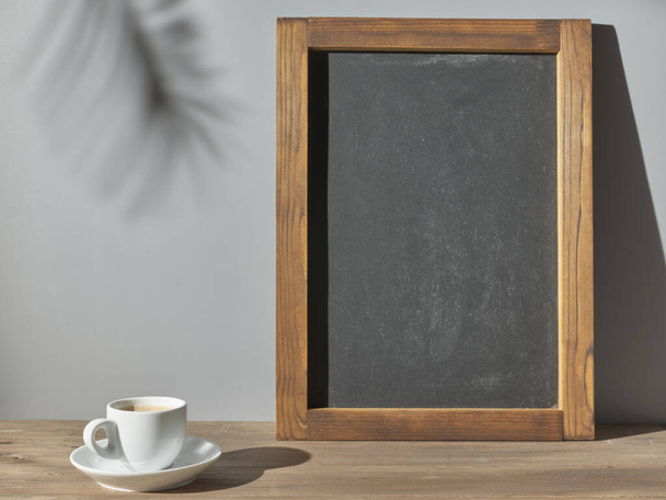 Chalk board on the table and a cup of espresso - Φωτογραφία, εικόνα