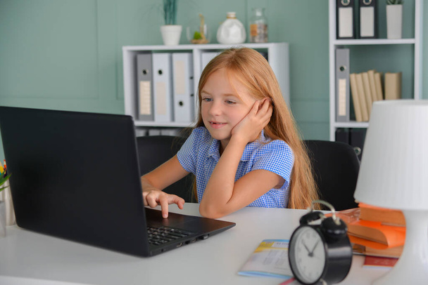 Pretty stylish schoolgirl studying homework math during her online lesson at home, social distance during quarantine, self-isolation, online education concept, home schooler - Photo, Image