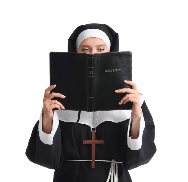 Young nun with Bible on white background - Valokuva, kuva