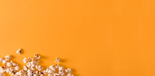 Popcorn on yellow background. Flat lay. Copy space. Movie time. - Photo, Image