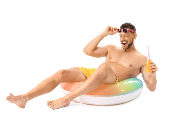 Young man with inflatable ring and juice on white background - Foto, afbeelding