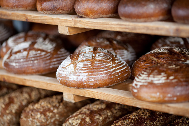 Breads on shelves in bakery - Fotó, kép