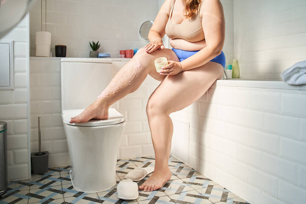 Girl holding creme jar and while preparing to using moisturizer - Photo, Image