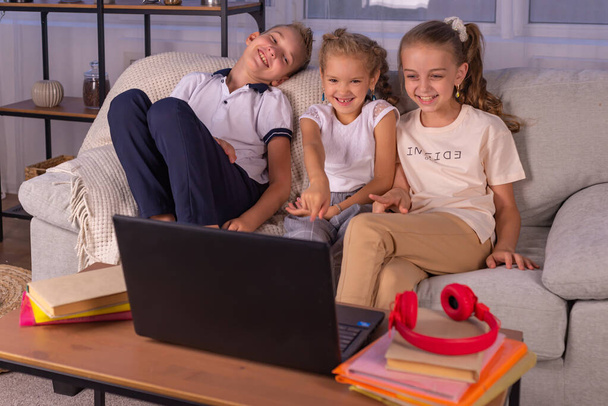 happy family together. brother and two sisters play at home. home schooling concept - Foto, Imagen