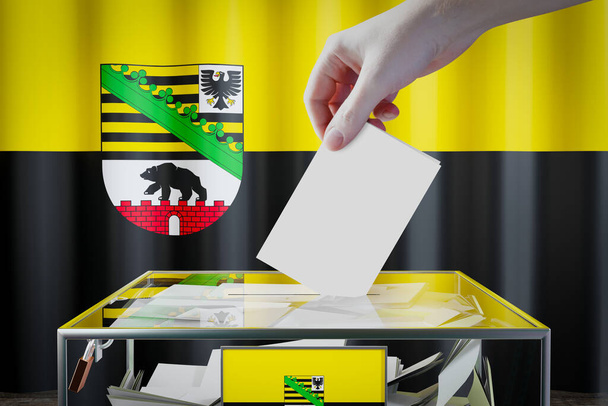 Прапор Саксонії-Ангальта, який скидає бюлетені в коробку - голосування / вибори в німецькій концепції - 3D ілюстрація - Фото, зображення