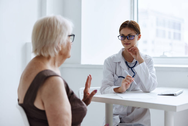elderly woman talking to the nurse doctor assistant - Photo, image
