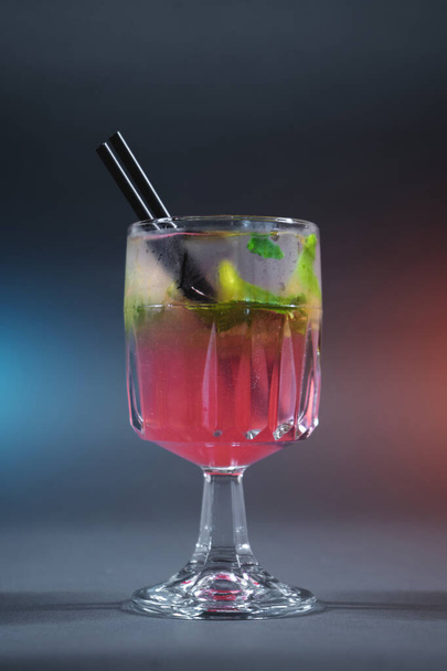 refreshing pink lemonade with mint or rose cocktail in glass on grey background - Foto, immagini