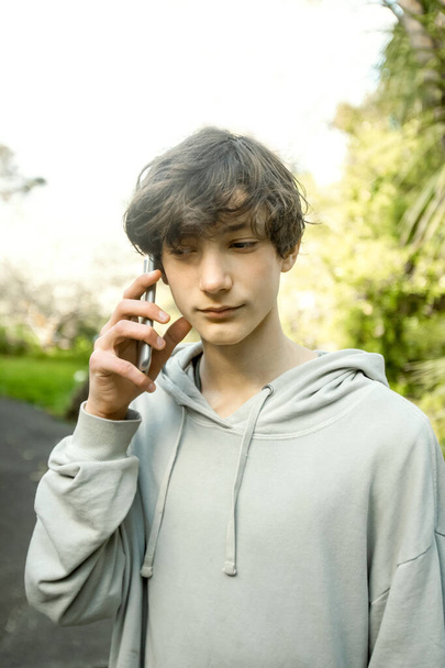 Hands of teenager boy holding phone with green screen, adolescent boy using phone, modern digital technologies - Foto, Imagen