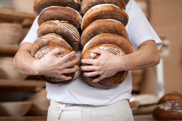 Worker carrying bread - Fotografie, Obrázek