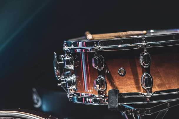 Close-up of a snare drum, percussion instrument on a dark background with beautiful lighting, copy space. - Zdjęcie, obraz