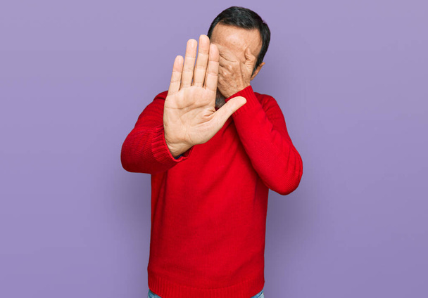 Middle age hispanic man wearing casual clothes covering eyes with hands and doing stop gesture with sad and fear expression. embarrassed and negative concept.  - Zdjęcie, obraz