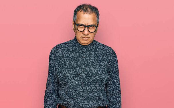 Middle age indian man wearing casual clothes and glasses skeptic and nervous, frowning upset because of problem. negative person.  - Photo, Image