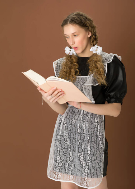 Emotional teen girl reading book with open mouth - Fotoğraf, Görsel