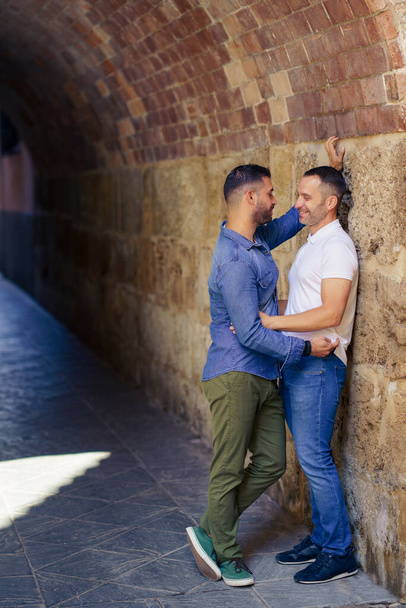 Gay couple hugging in a romantic moment outdoors - Valokuva, kuva