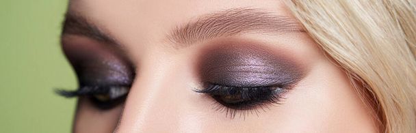 Closeup shot of woman eye with evening makeup. Long eyelashes. Smokey Eyes - Фото, изображение