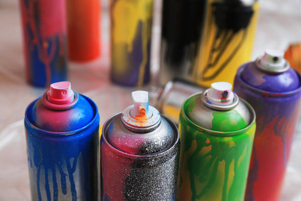 Used cans of spray paints indoors, closeup. Graffiti supplies - Fotó, kép