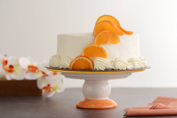 vanilla cake with orange slices on wood table - Foto, Imagem