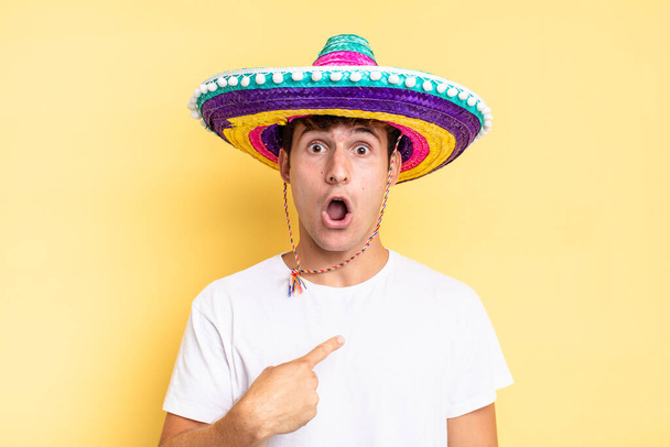 looking shocked and surprised with mouth wide open, pointing to self. mexican hat concept - Фото, зображення