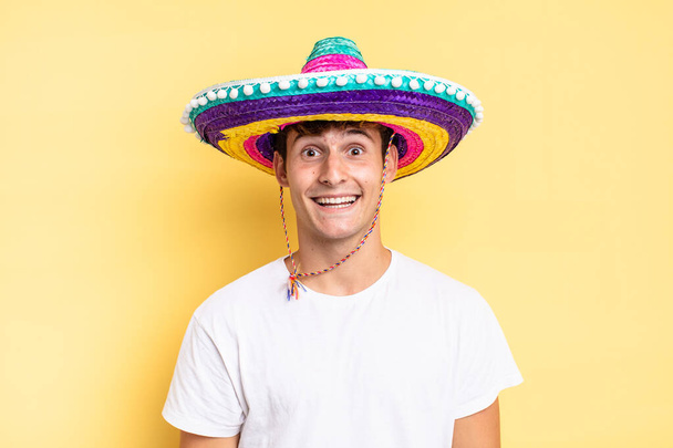 looking happy and pleasantly surprised, excited with a fascinated and shocked expression. mexican hat concept - Φωτογραφία, εικόνα