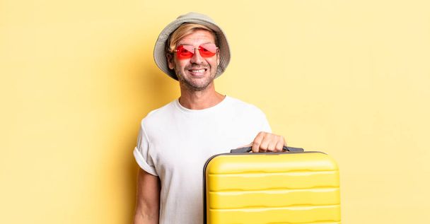 blond adult man looking happy and pleasantly surprised. traveler concept - Foto, Imagen