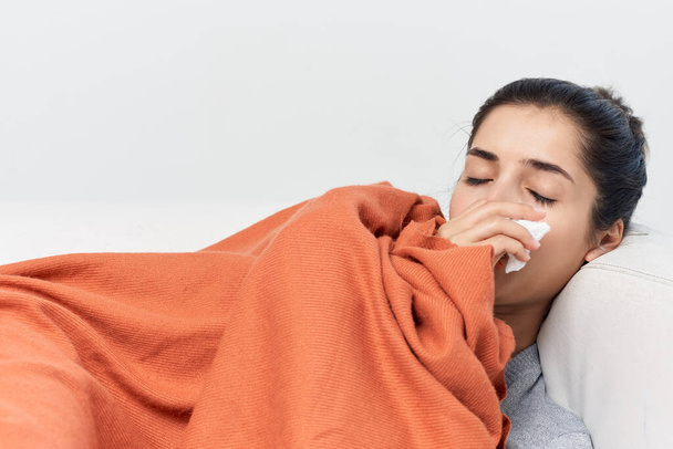 woman lies with closed eyes covered with a blanket cold treatment - Foto, Imagem