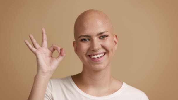 Bald Woman Gesturing Okay Sign Smiling Standing Over Beige Background - Footage, Video