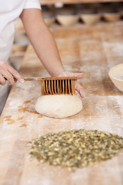 Chef applying butter on dough - Fotoğraf, Görsel