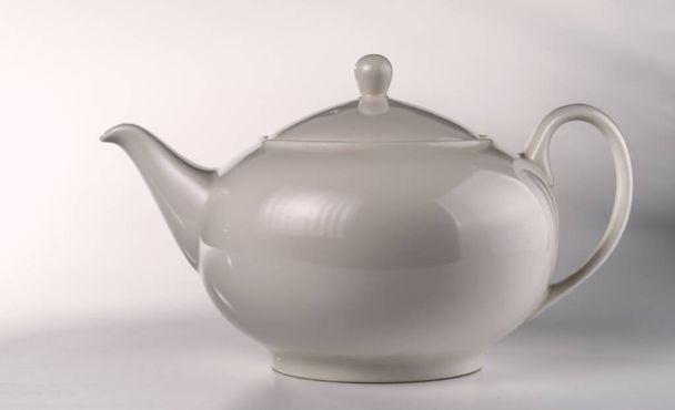 Light gray ceramic teapot on a light background.  - Photo, Image